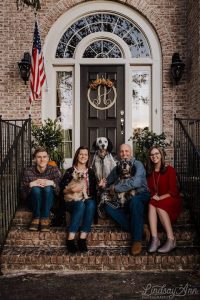 The Anderson family sitting on their front steps.