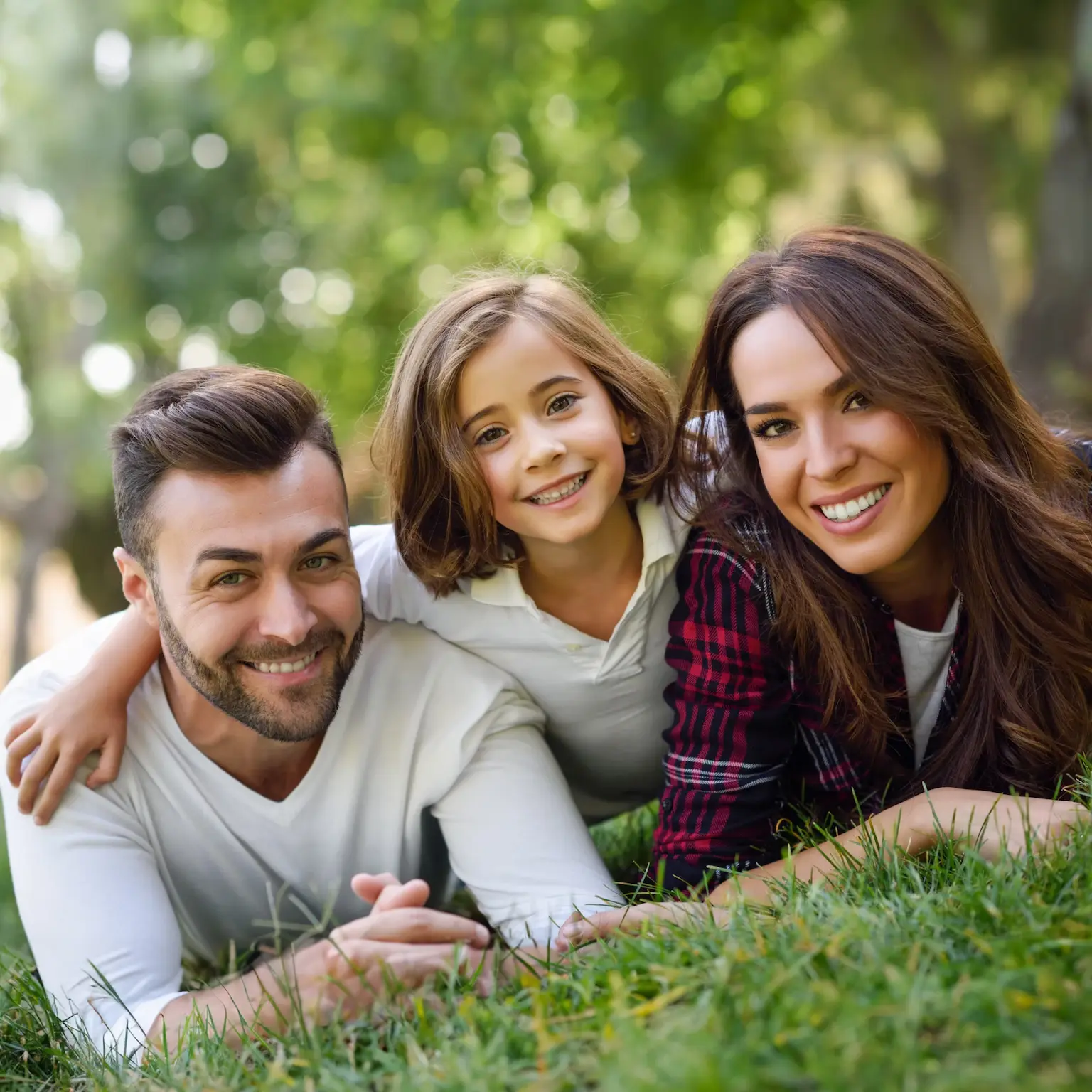 Acworth couple with their daughter smiling bright after seeing family and cosmetic dentist in Kennesaw