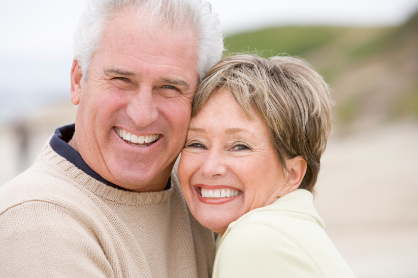 A smiling older couple enjoying the benefits of restorative dentistry in Kennesaw.